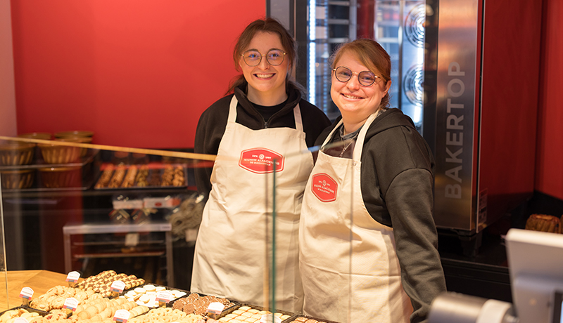 The two welcoming sellers of the Boutique des Ménétriers (in RIbeauvillé), next to the oven and the biscuits.